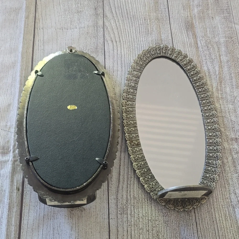 Set of 2 new silver, oval shaped ornate mirror sconces.